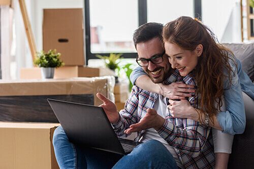 Happy Couple Looking at a Laptop Computer